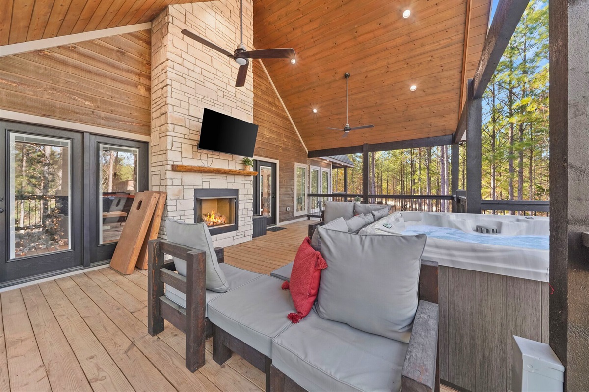 Open-concept living and dining area with stone fireplace.
