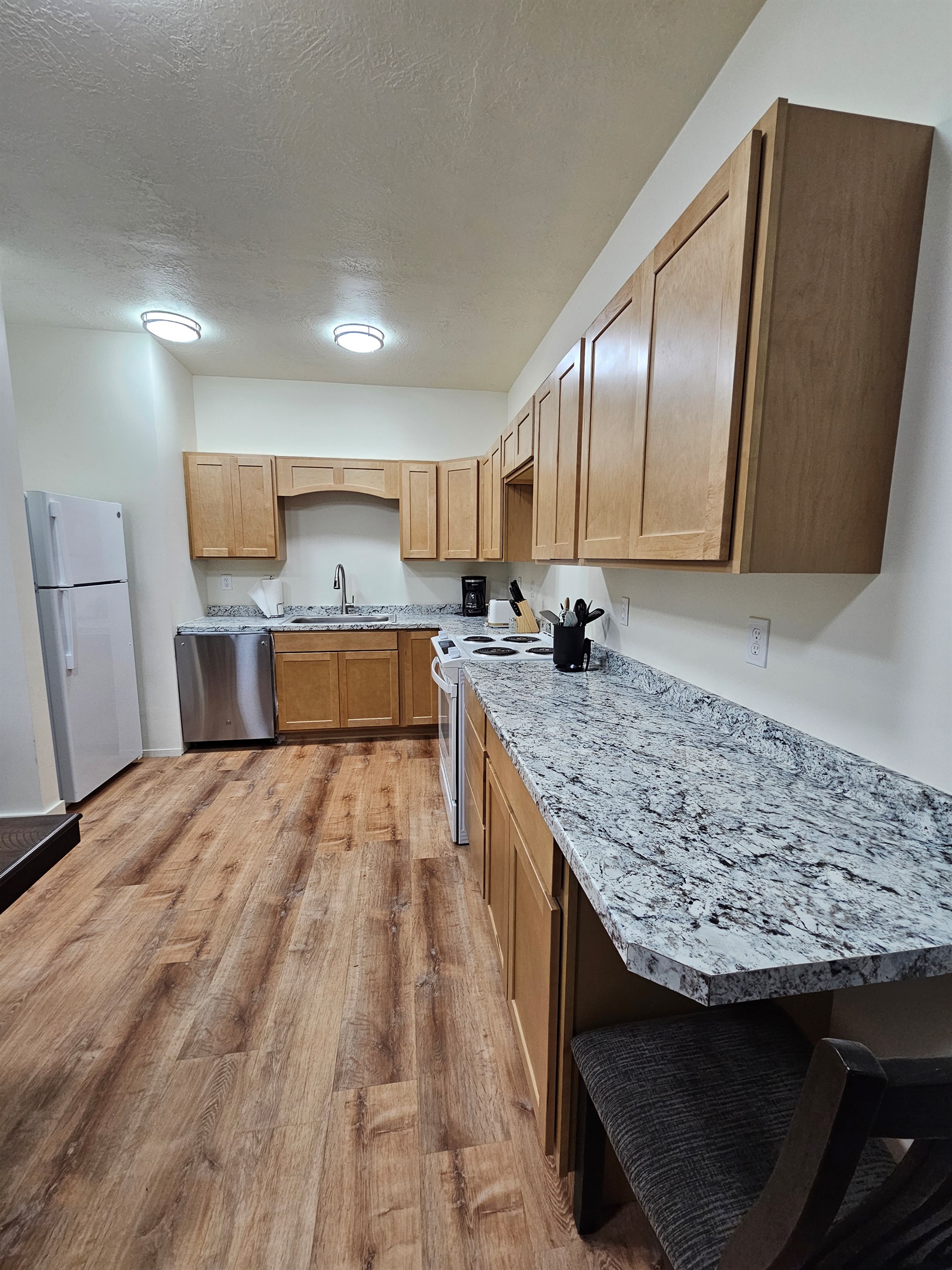 Full Kitchen with Dishwasher, Stove, and Refrigerator