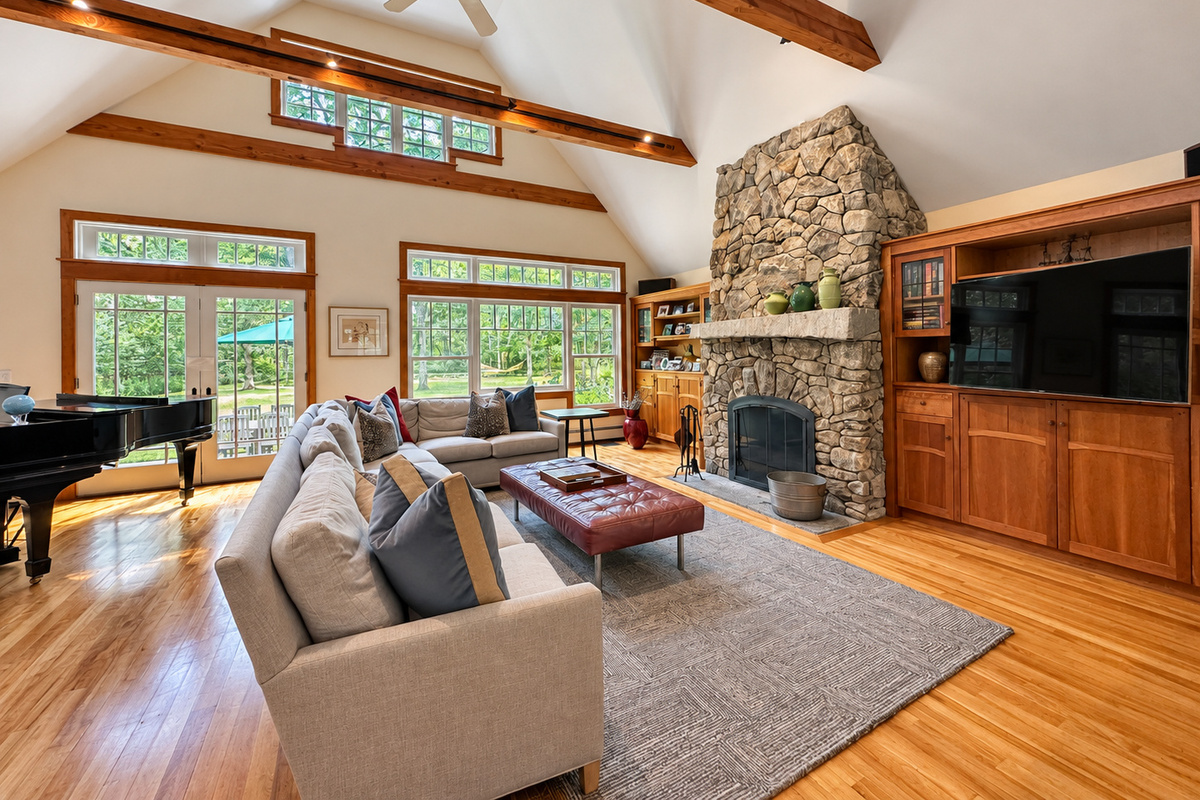 Living room with stone fireplace and piano