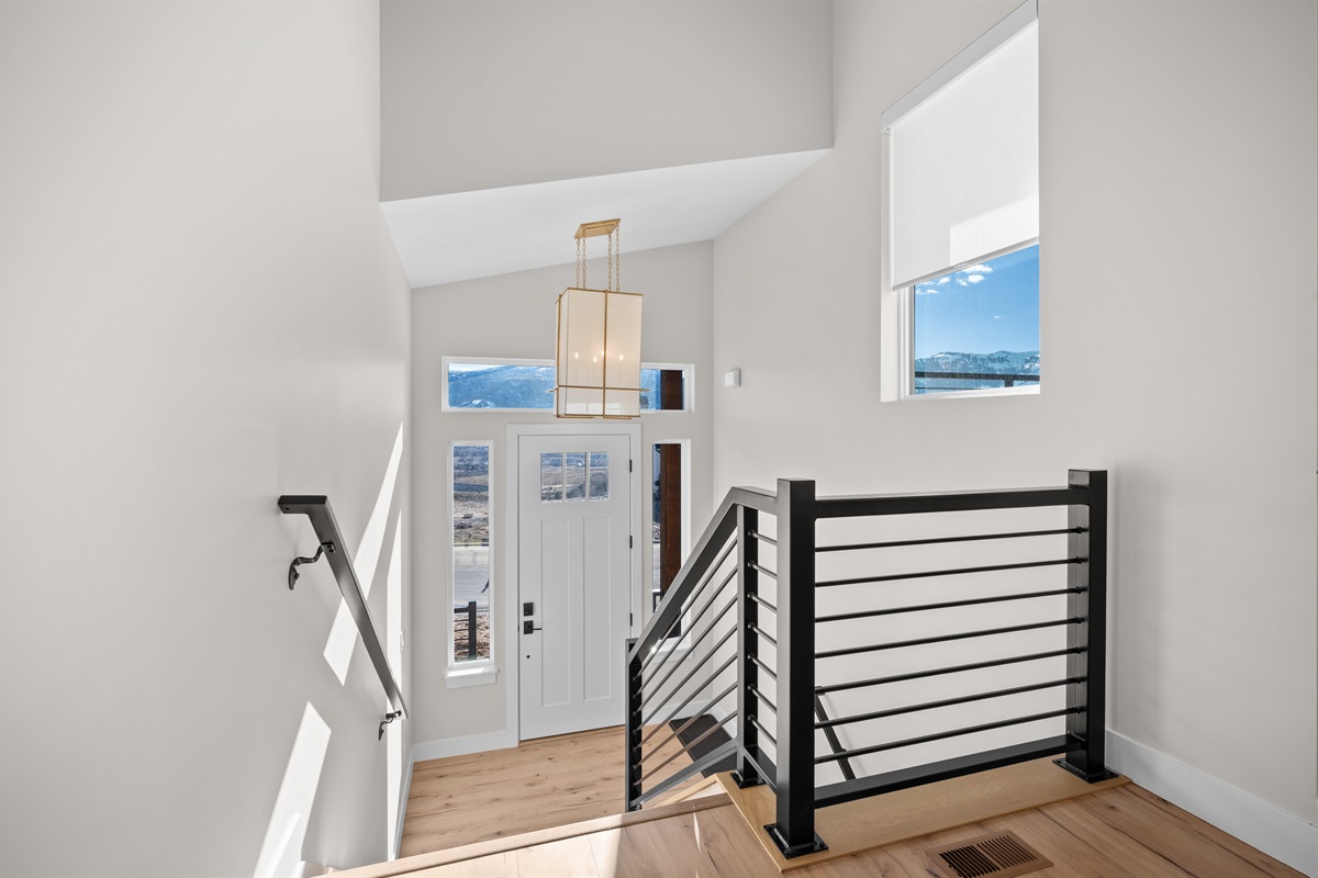 Modern entryway with clean architectural lines and natural light welcoming you to your mountain retreat.