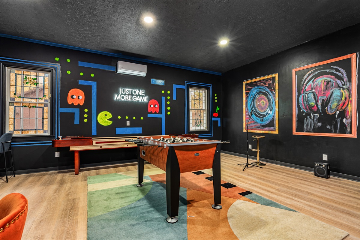Arcade-night energy with shuffleboard, Pac-Man art, and endless games for all ages