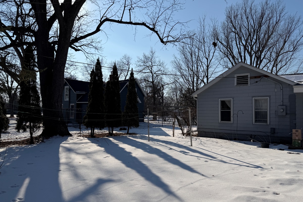 There's a cute little backyard with a wildflower garden, hidden under the snow in this picture.