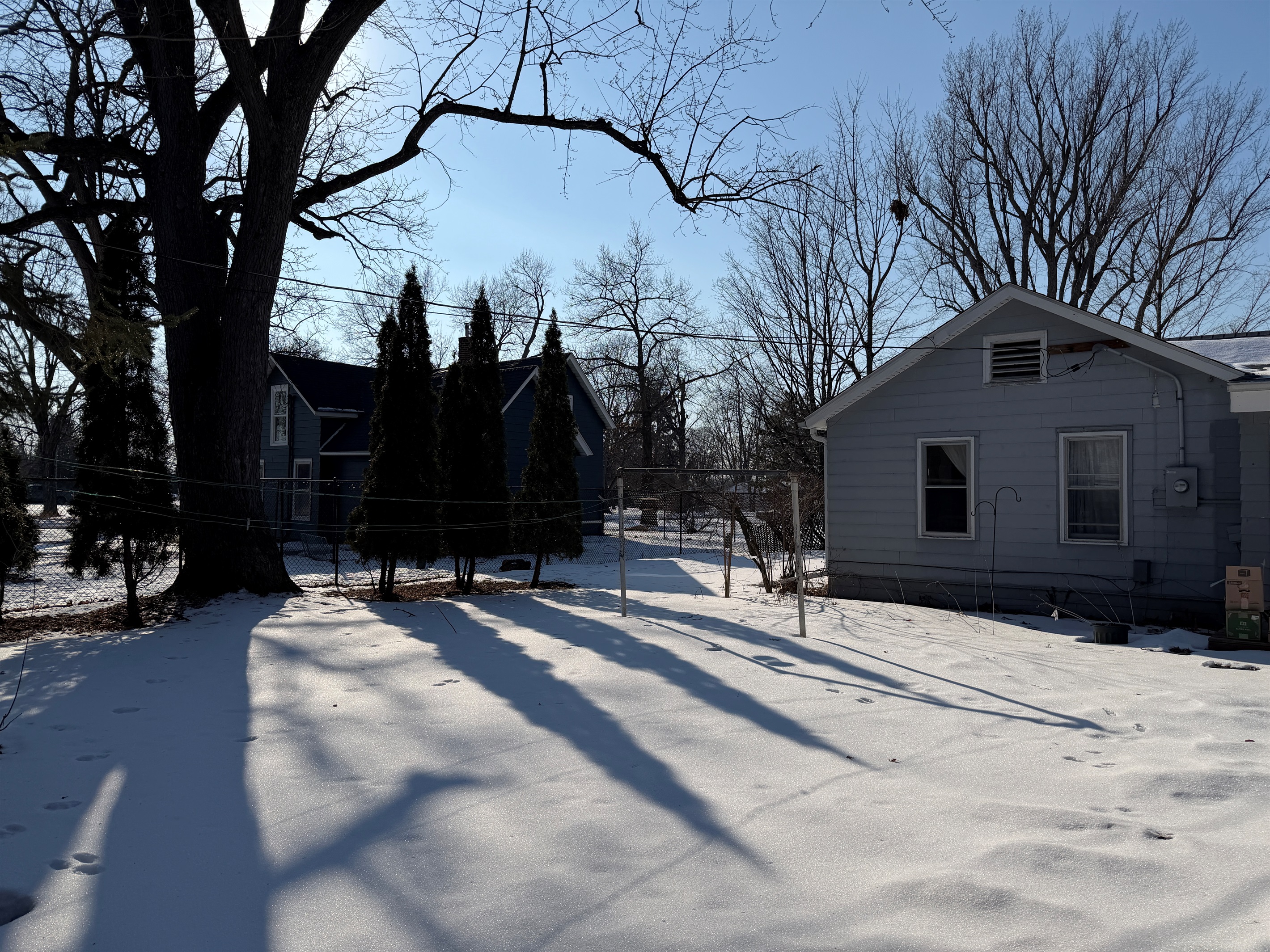 There's a cute little backyard with a wildflower garden, hidden under the snow in this picture.