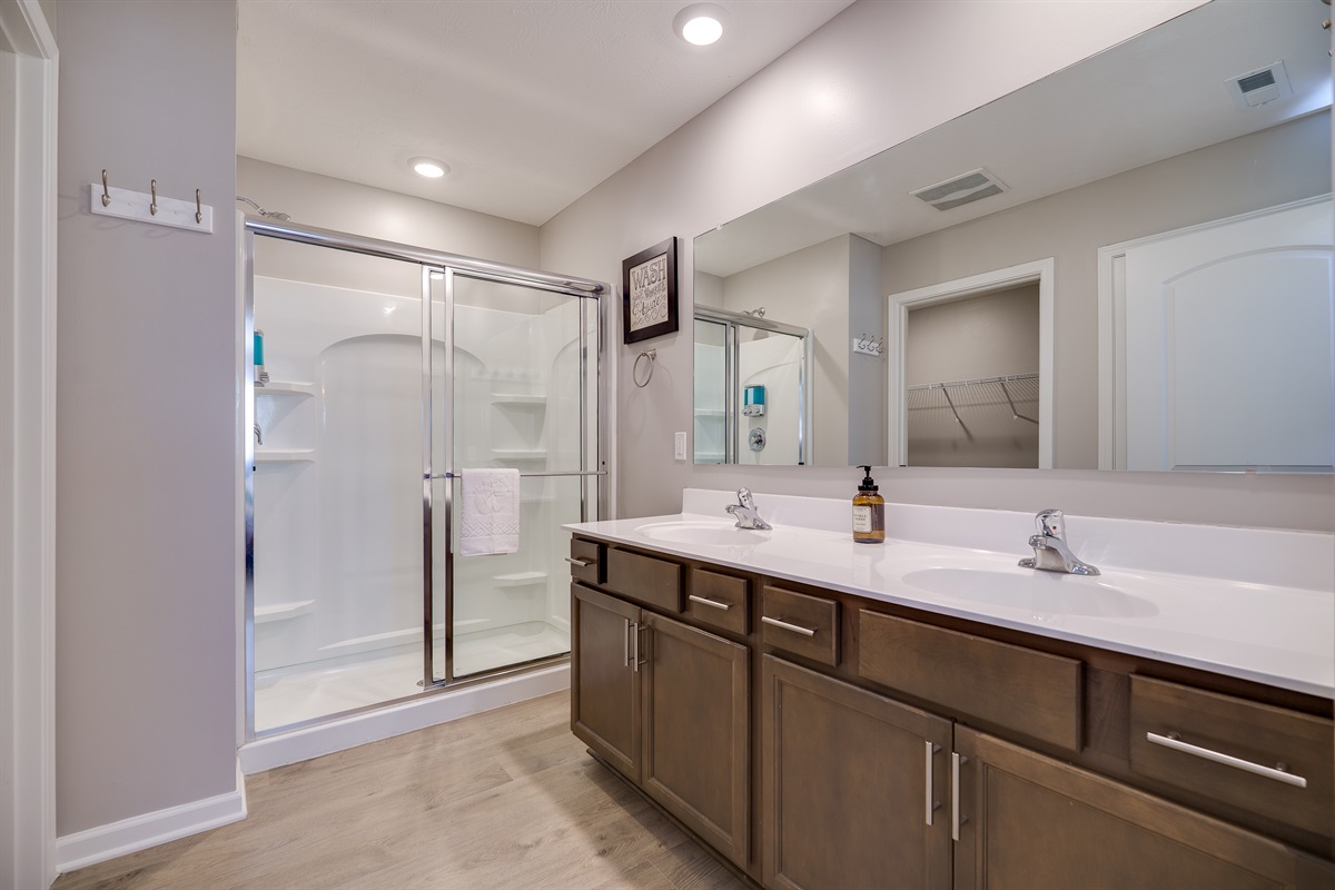 Stylish bathroom with double sinks and a sleek walk-in shower