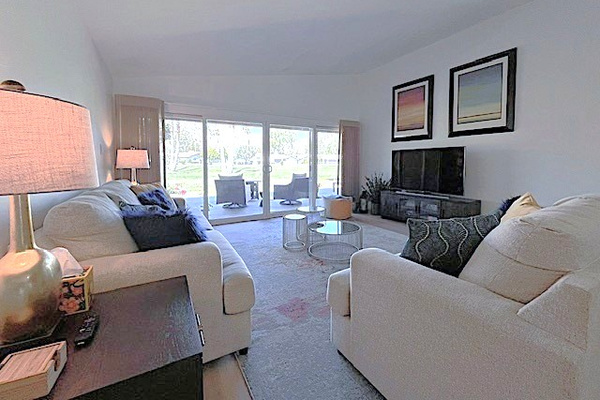 Living room has great views, flat screen, and remote control shades.