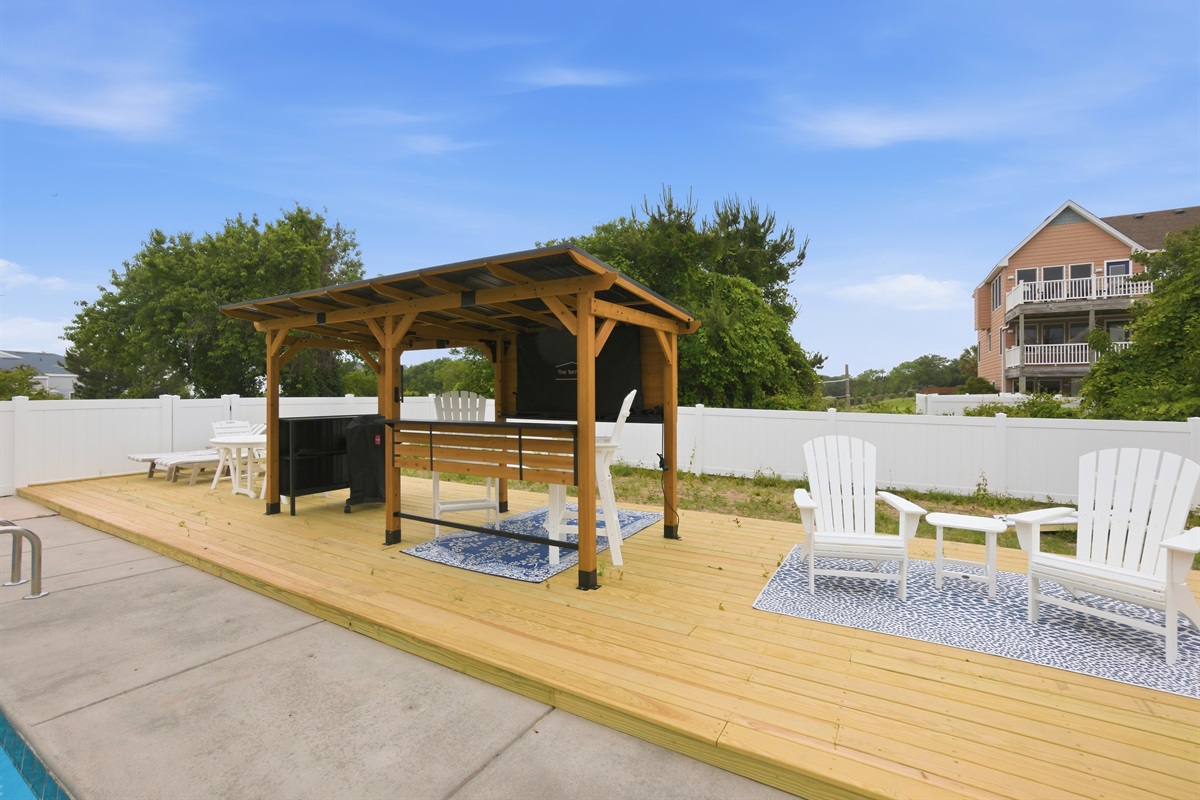 Poolside lounge area with shaded seating and plenty of room to relax.