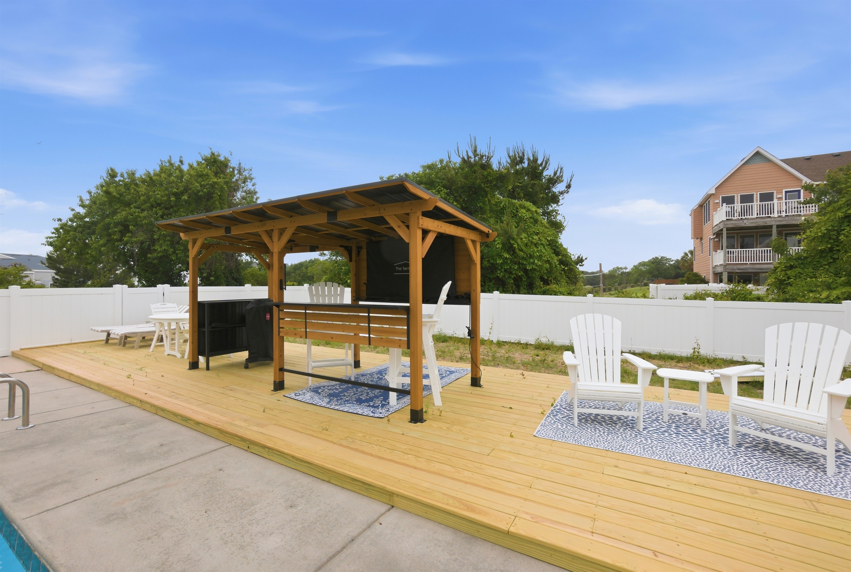 Poolside lounge area with shaded seating and plenty of room to relax.