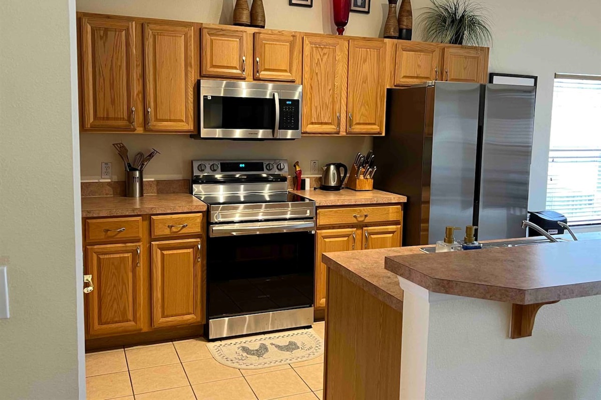 Recently updated appliances in kitchen, overlooking Living Room 2 with a Smart TV 