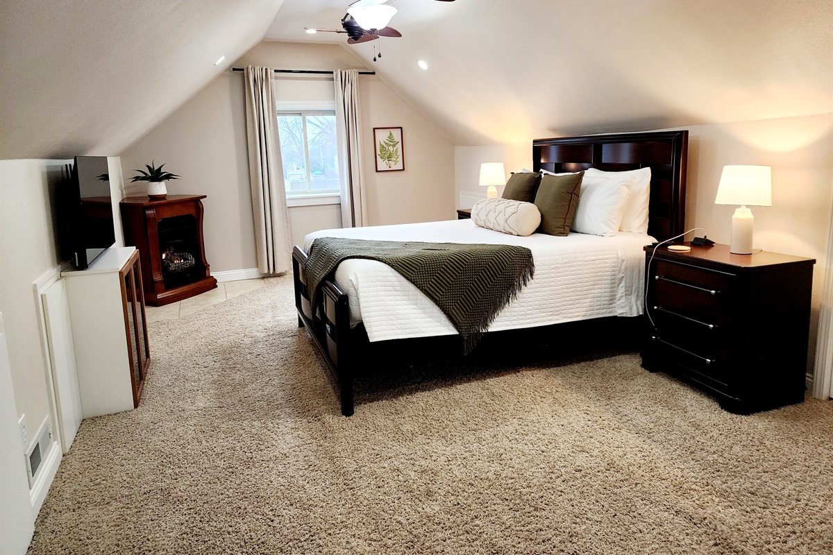 Master bedroom with a smart tv.