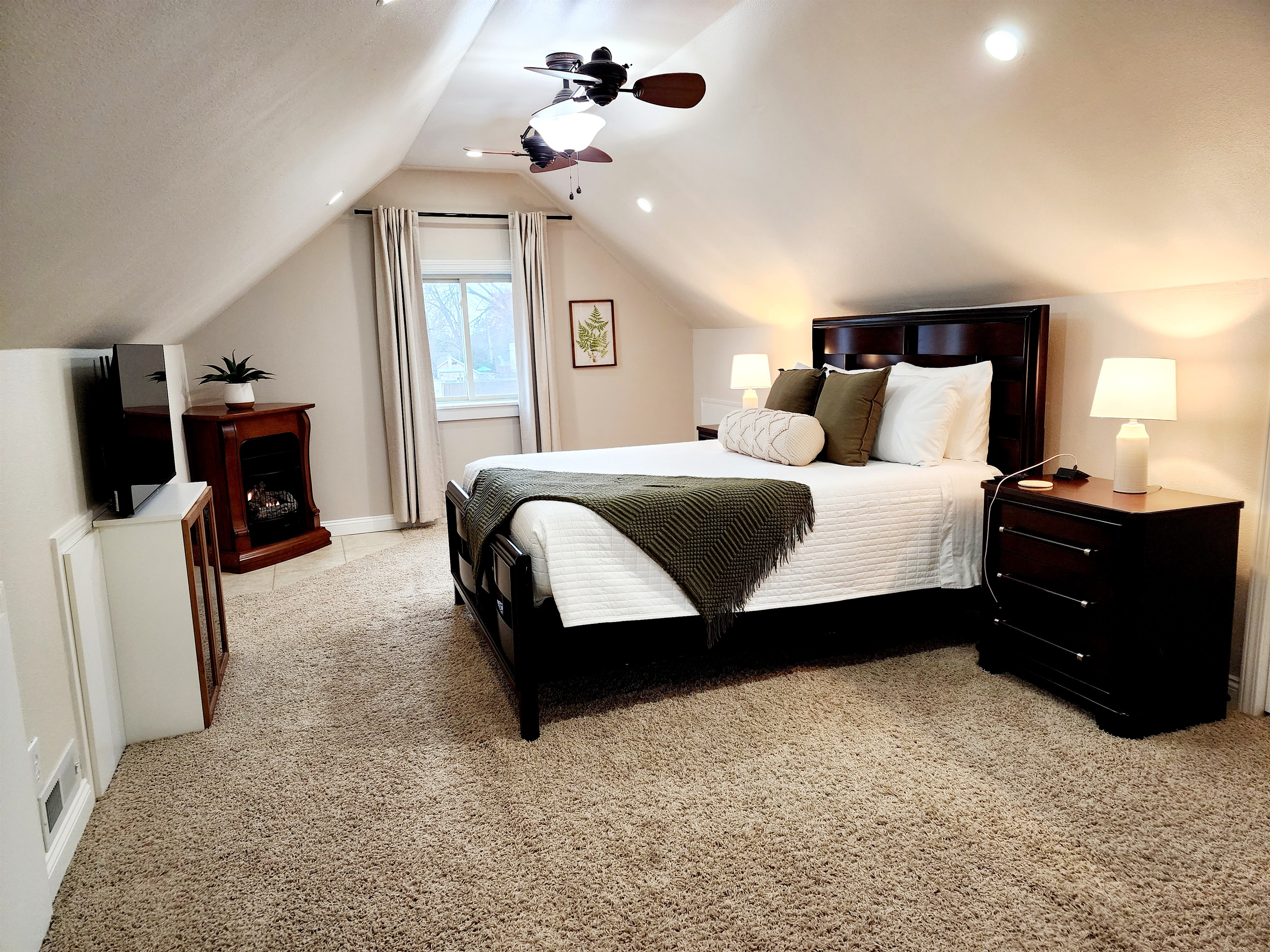 Master bedroom with a smart tv.