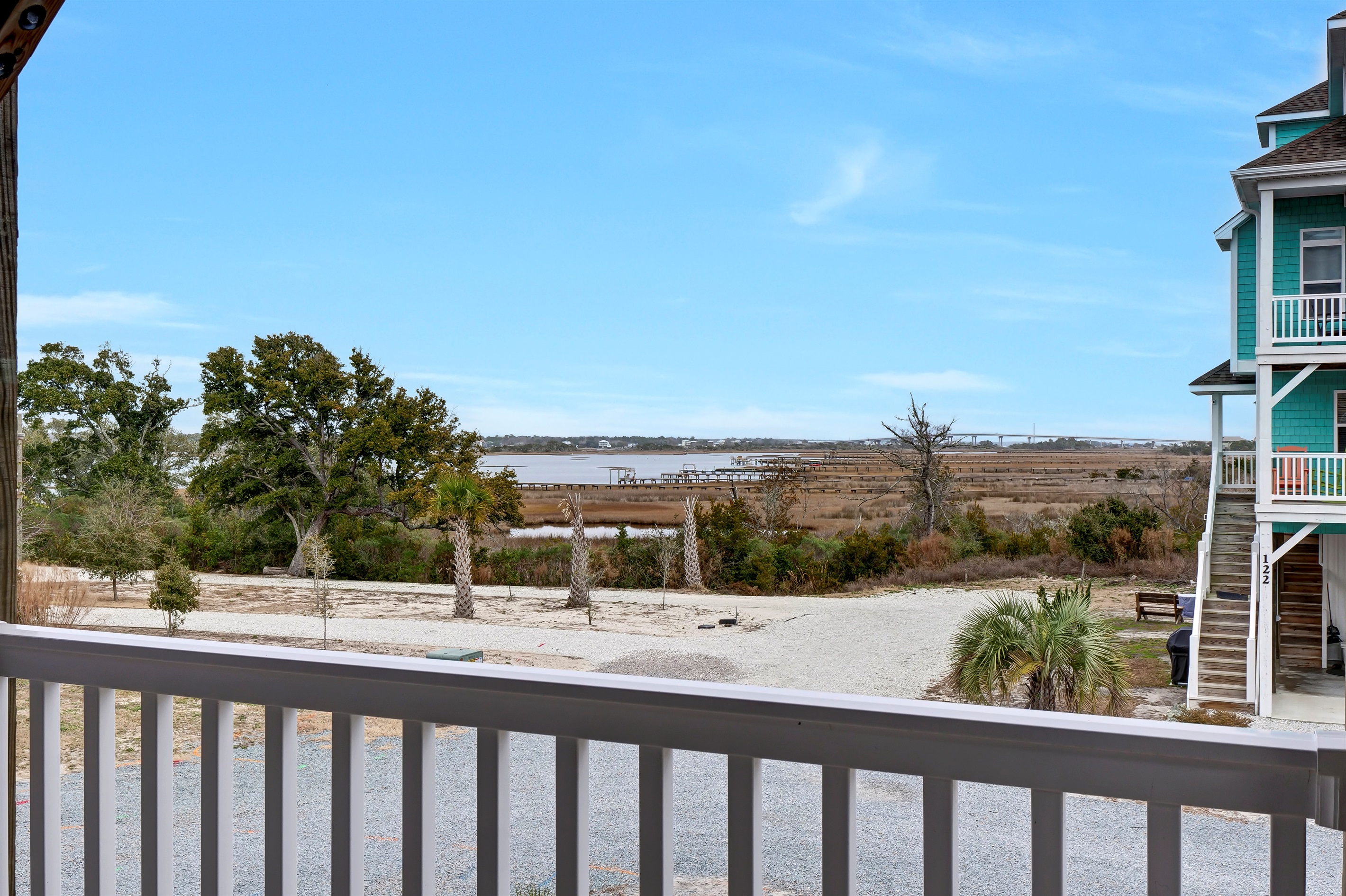 Enjoy serene views of the Surf City High-rise Bridge framed by graceful birds in flight 