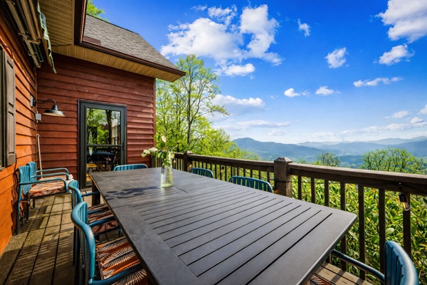Outdoor dining just off the great room, with plenty of seating and mountain views—perfect for shared meals and time together.