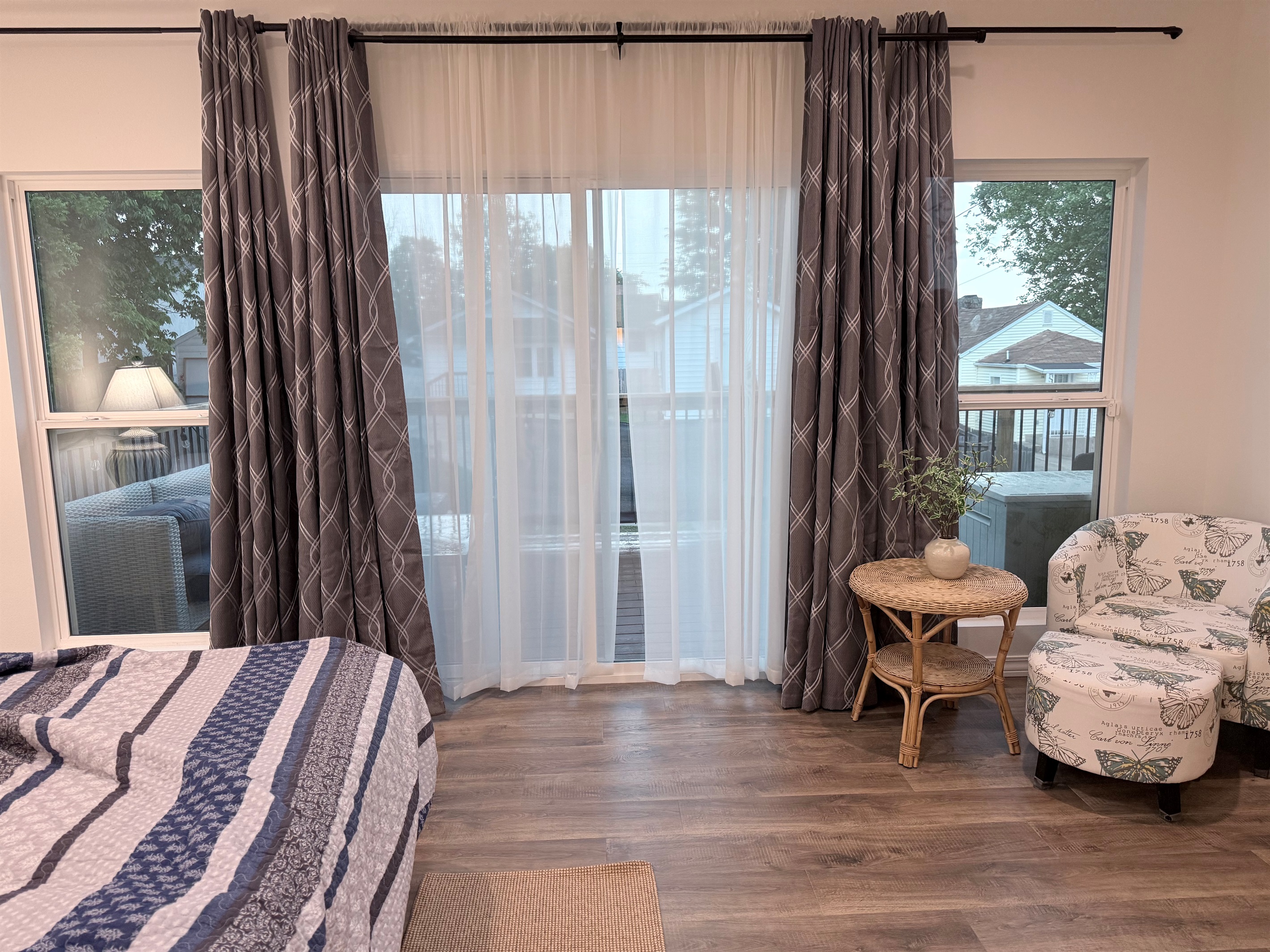 View of large glass windows in master bedroom leading to 10 by 25' composite deck with view of downtown,