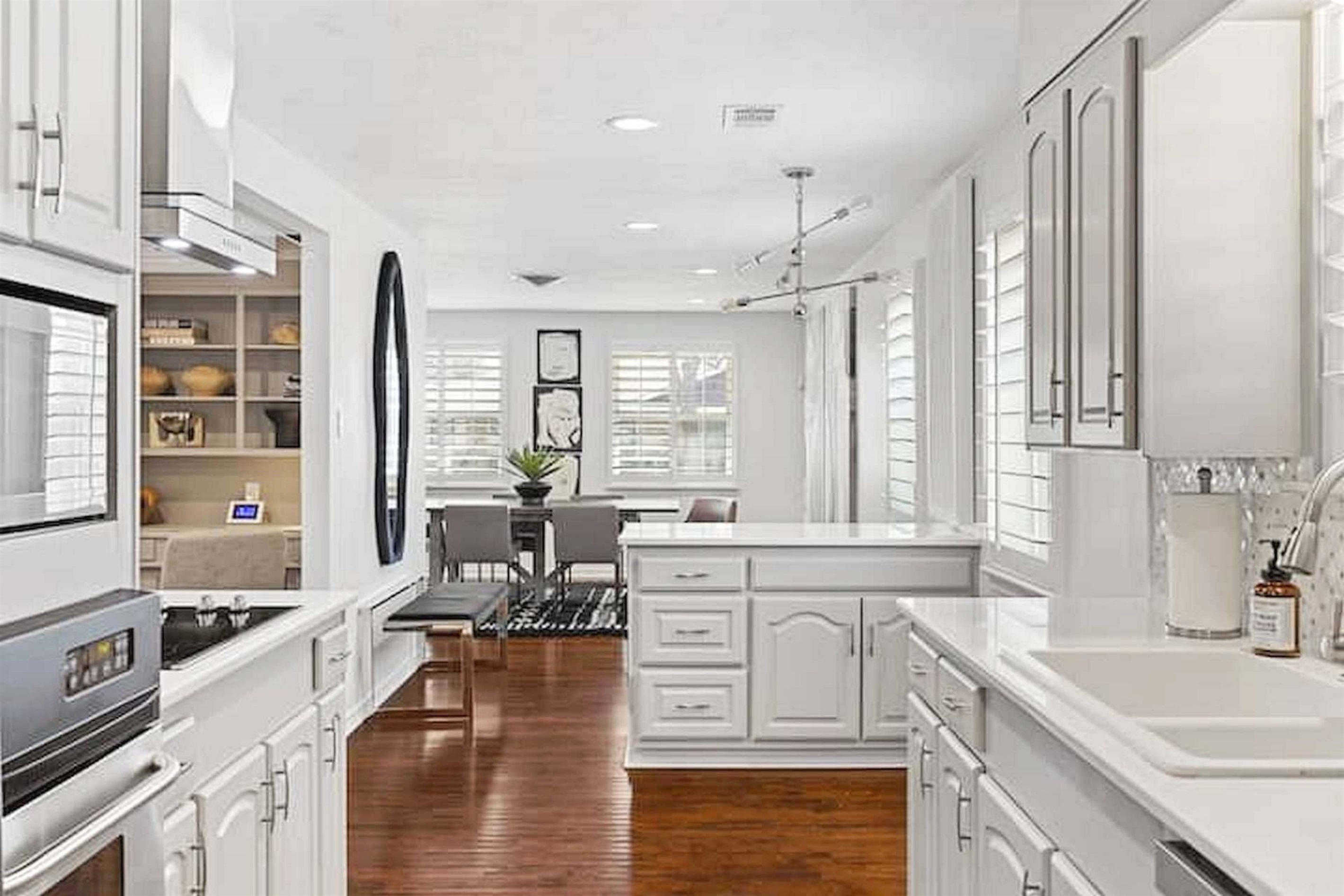 Bright chef-inspired kitchen with crisp white cabinetry and an open-concept layout perfect for entertaining.