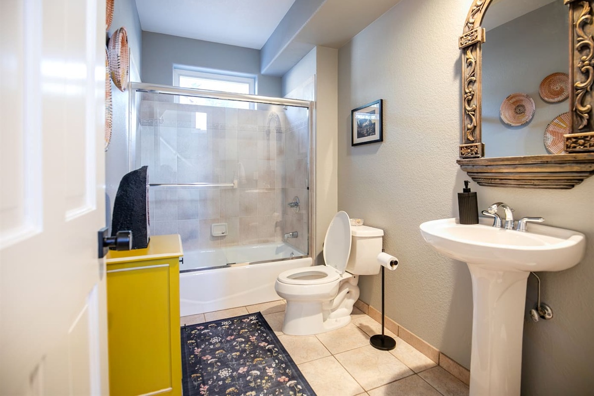 Our full bathroom on the main level is complete with soft towels, shower and tub.