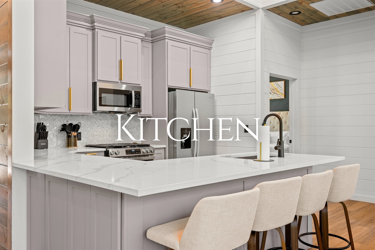 The kitchen features modern finishes, ample counter space, and seating that keeps everyone connected while meals are prepared.