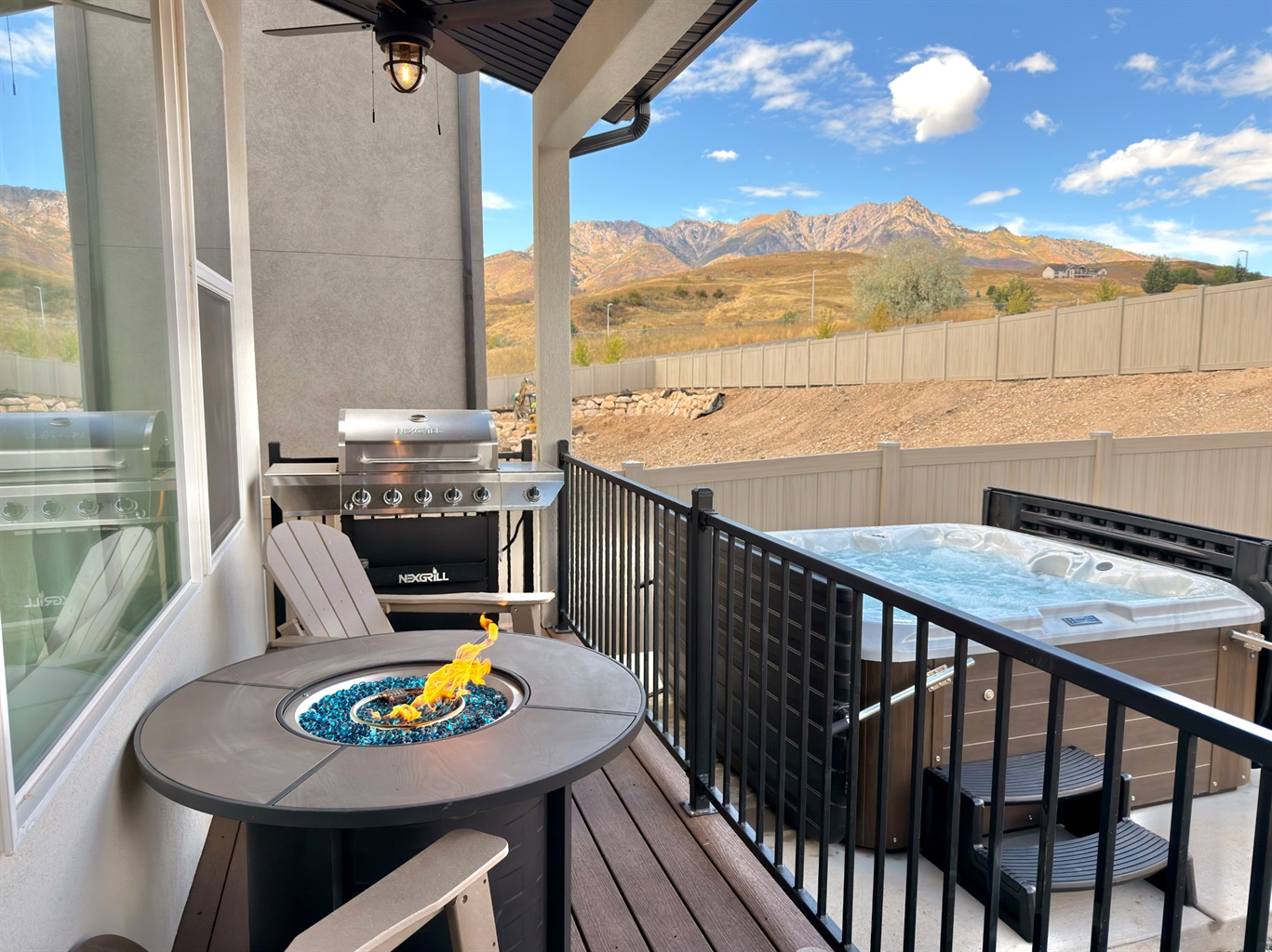 Outdoor deck with private hot tub and BBQ grill — unwind while soaking up scenic mountain views.