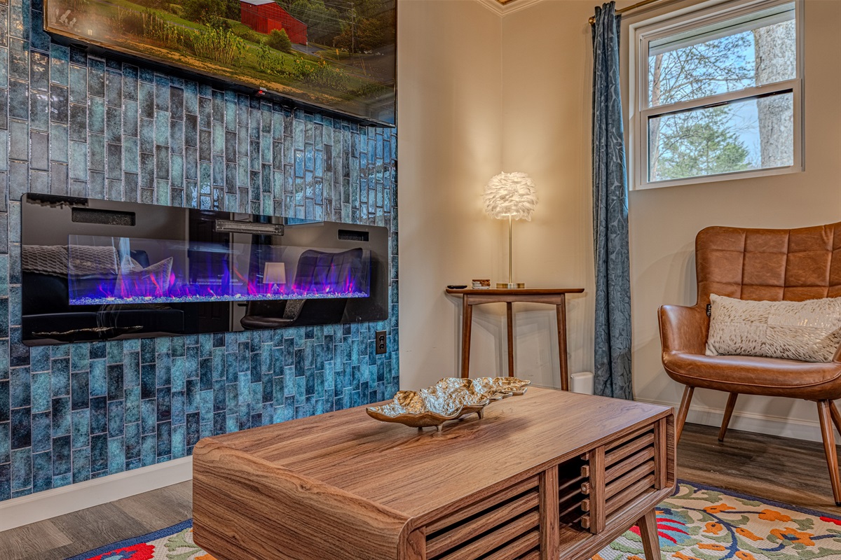 Unwind on a quiet afternoon by the glow of the fireplace. The soft lighting and plush accents make this the perfect nook for reading or a peaceful nap.