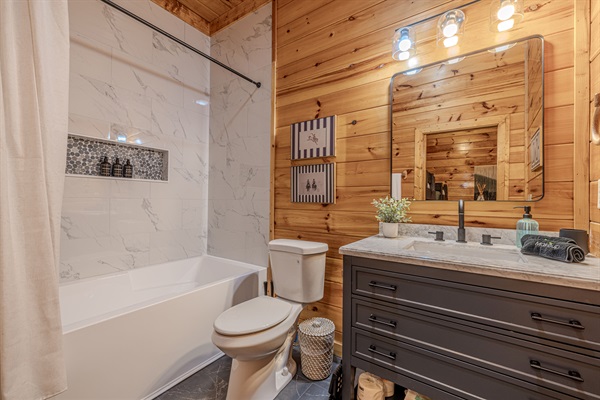 The connected bunk room has a full bath with a large tub