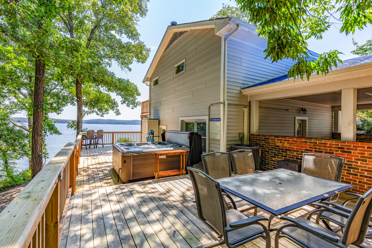 The lakefront deck combines a private hot tub, outdoor dining, and room for your group to relax together.
