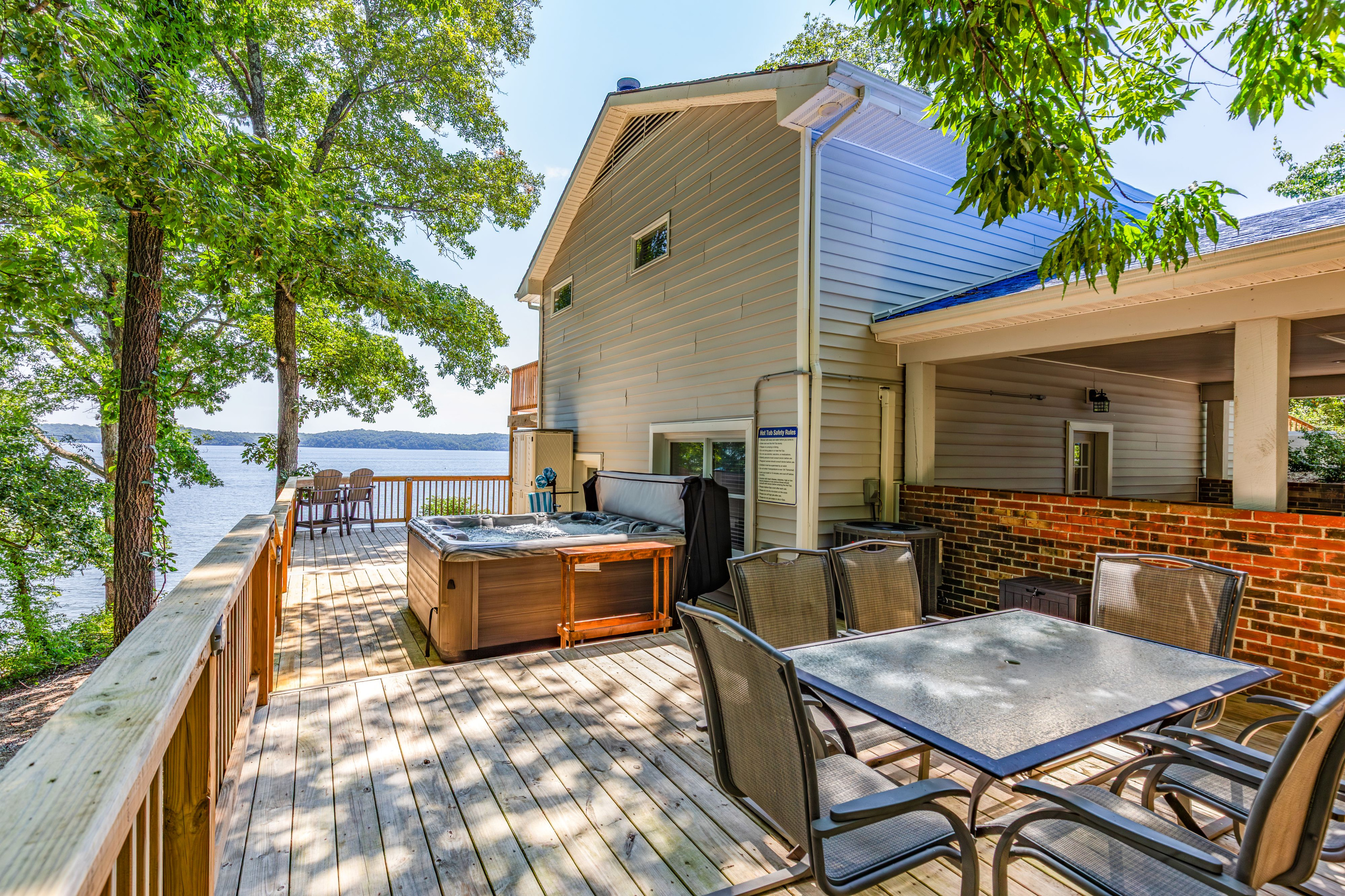 The lakefront deck combines a private hot tub, outdoor dining, and room for your group to relax together.