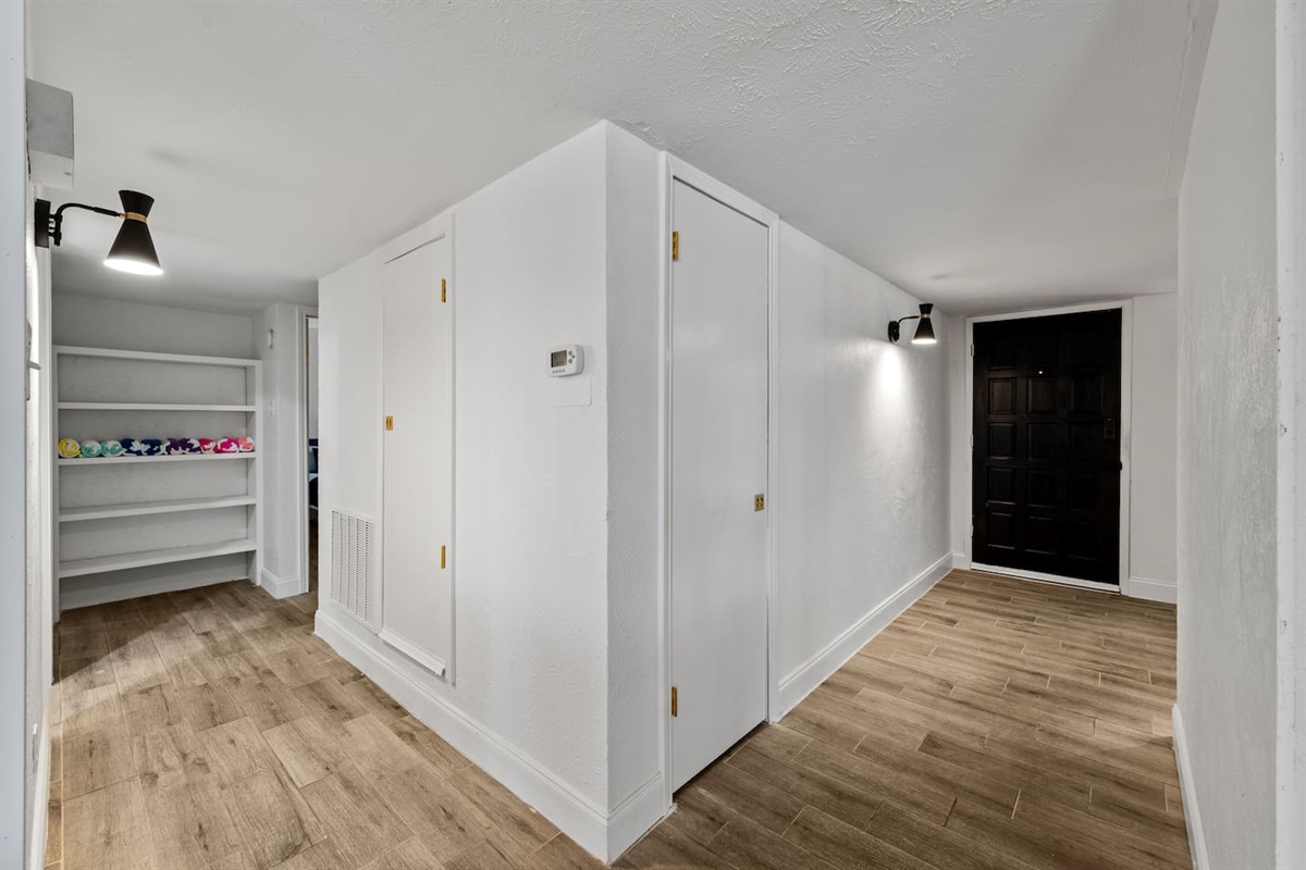 Clean, wide hallway with modern finishes that connect the home’s stylish layout.