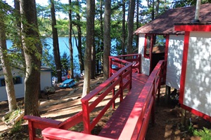 Stairs and cabin entrance with lake view on the background