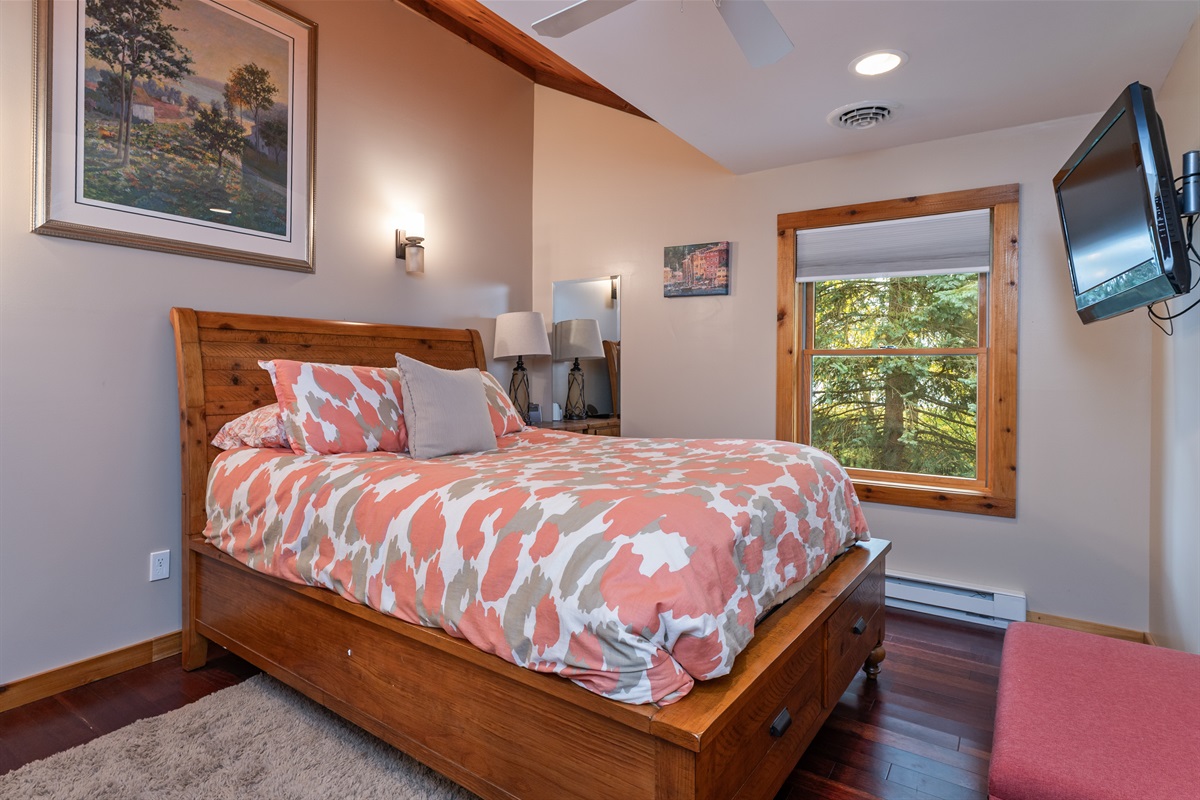 Inviting bedroom with rustic wood accents and soft bedding.