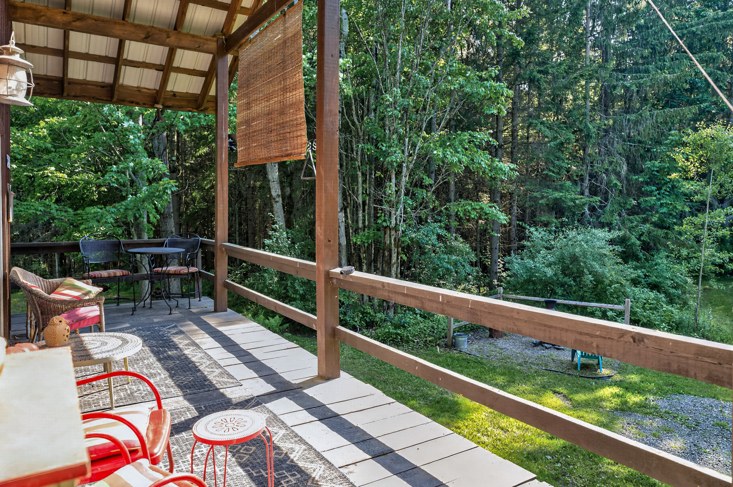 Deck with red seating overlooking the woods