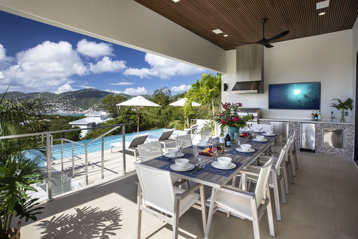 Pool deck with covered outdoor dining area, grill, tv and bar