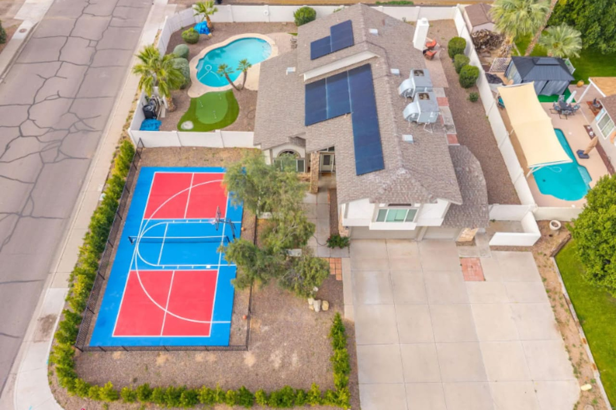Aerial view of resort compound featuring sports court, multiple pools, solar power, and extensive outdoor entertaining spaces.