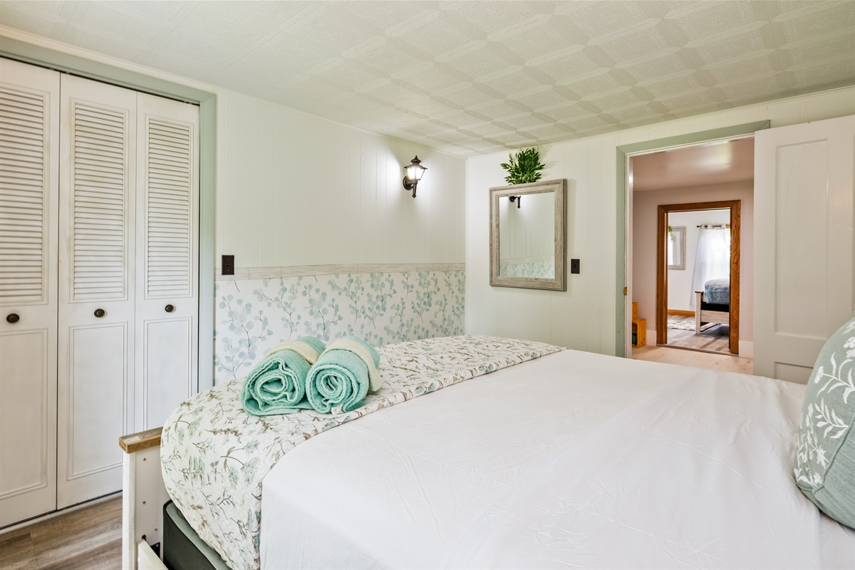 Wake up refreshed in this light-filled room with charming decor, ample storage, and calming, nature-inspired touches.