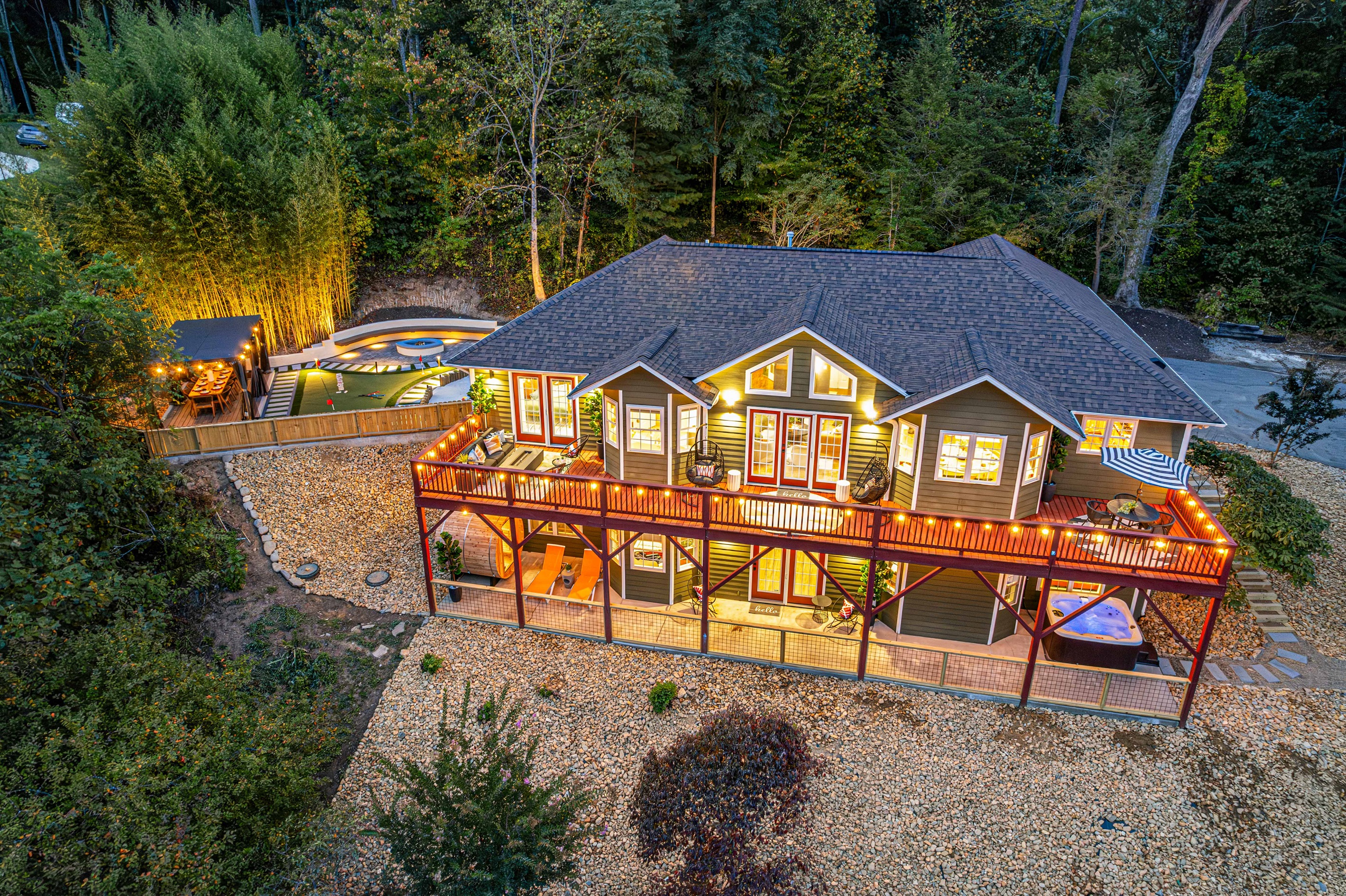 Experience the magic from above! This stunning drone shot highlights our home, adorned with string lights and a spacious backyard. Enjoy dining under the pergola for 10, play mini-putt, gather around the firepit, or let the kids explore the sandpit. 