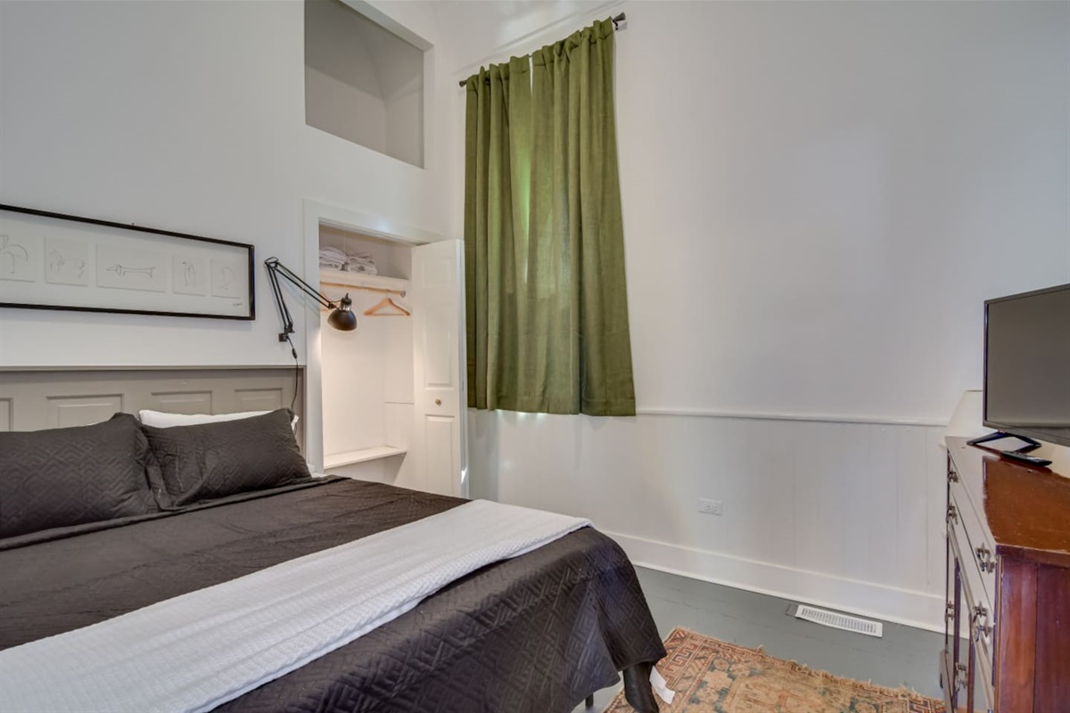 Spacious bedroom with modern black bedding.