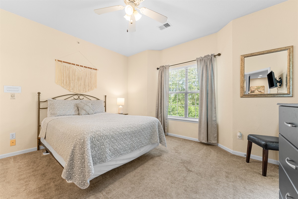 Primary queen bedroom with soft natural light and a calm, uncluttered feel for restful nights.