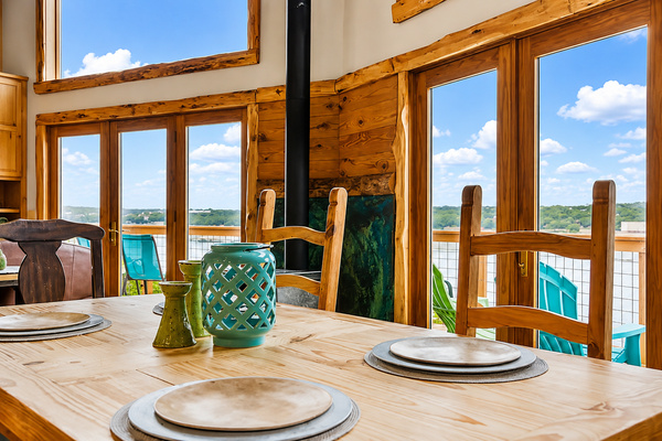 Gather around the dining table with beautiful Lake Travis views just beyond the windows. The warm wood interior and easy access to the deck create the perfect setting for family meals, morning coffee, and relaxed lake-house evenings.