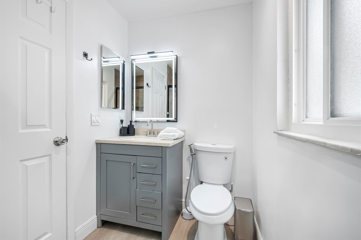A bold backlit vanity light makes morning prep and evening wind-down routines feel special.
