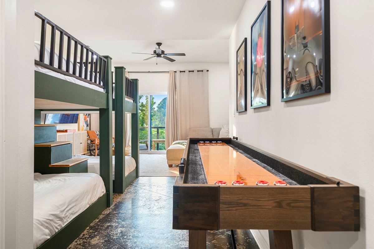 Fun bunk room with cozy beds and shuffleboard&mdash;perfect for kids or friends to unwind and play.