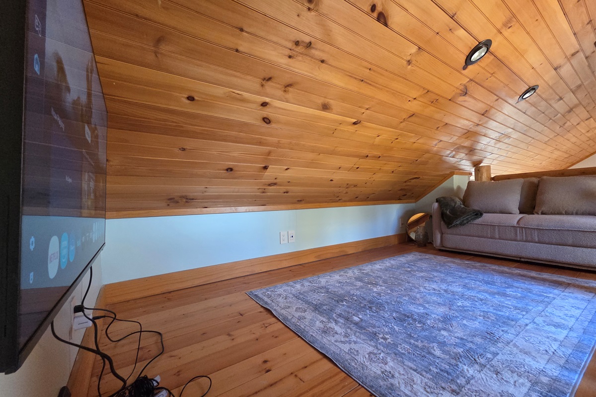 Kids (or adults!) can enjoy the loft above the carriage house bedroom, featuring a Smart TV with a gaming system—a cozy spot to relax, play games, or hang out apart from the main house