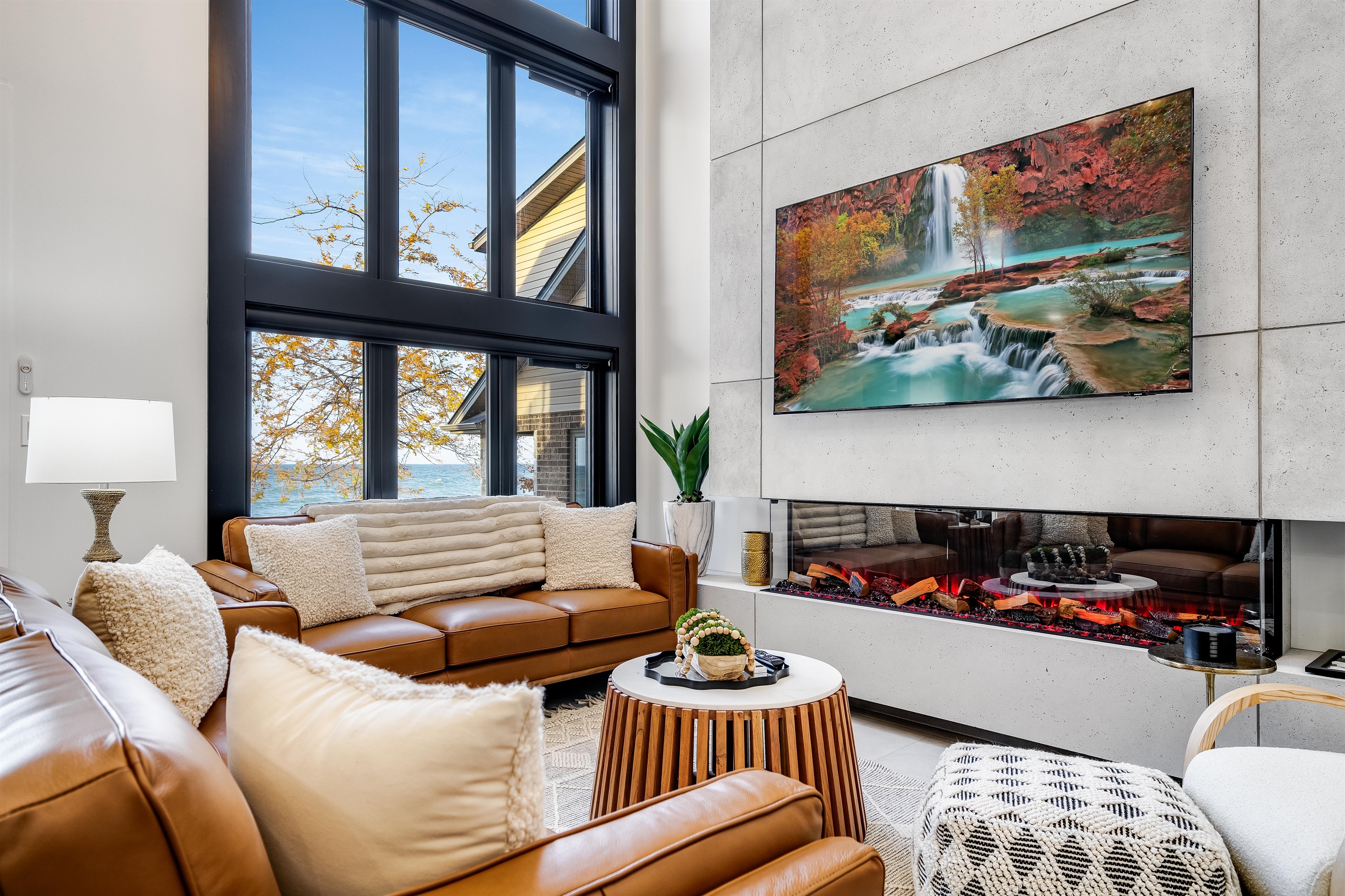 Orangish-brown accents in seating and cabinetry details create cohesion.