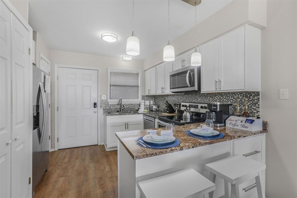 Kitchen with granite counter counter tops and stainless steel appliances including dishwasher. 