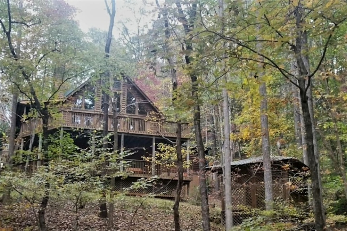 Back yard view with pavilion and steps down to walk to beach/lake/river.