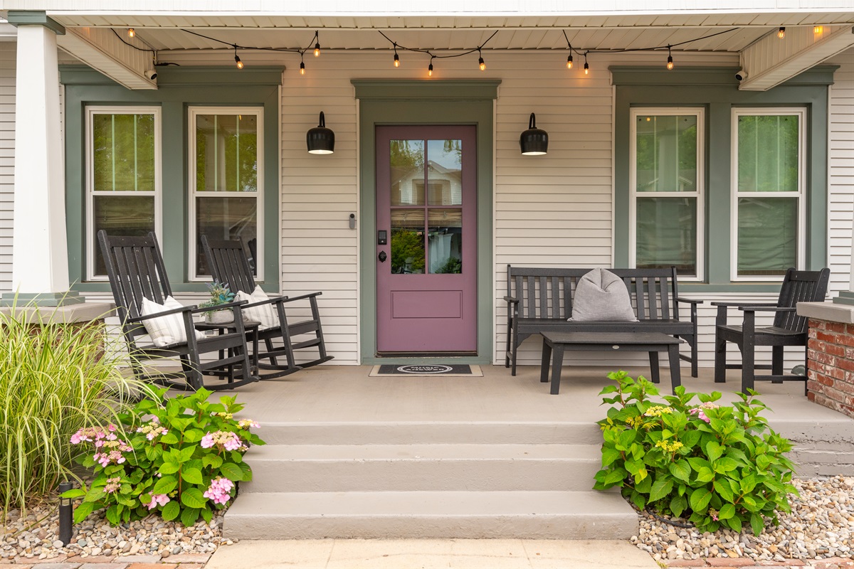 Classic craftsman front porch with fenced front yard.