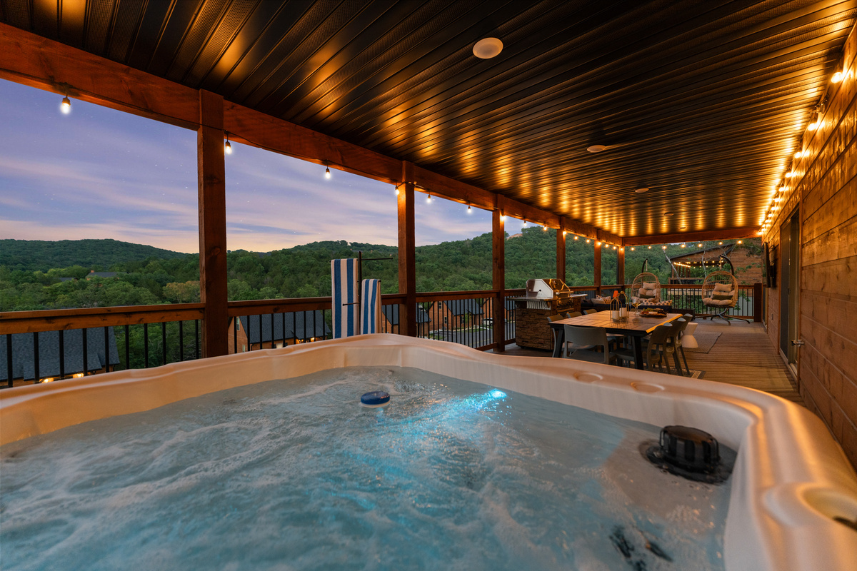 End the day soaking in the private hot tub beneath a purple Ozark sky, grill and dining glowing behind.