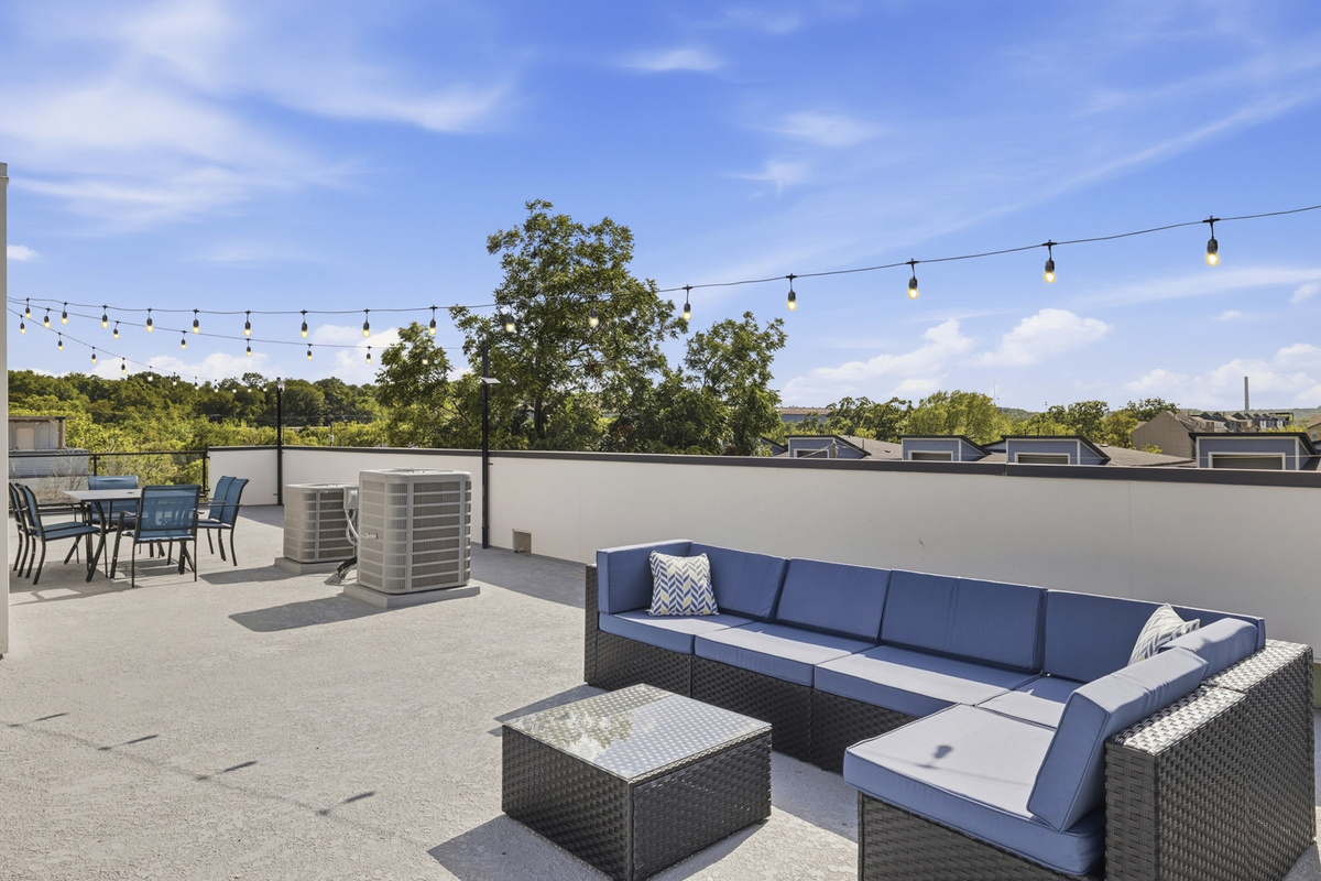 Unwind under string lights with stunning views and comfy seating!
