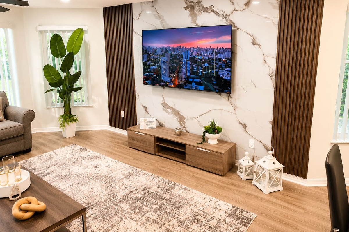 Stylish entertainment wall with a TV and marble-inspired finishes.