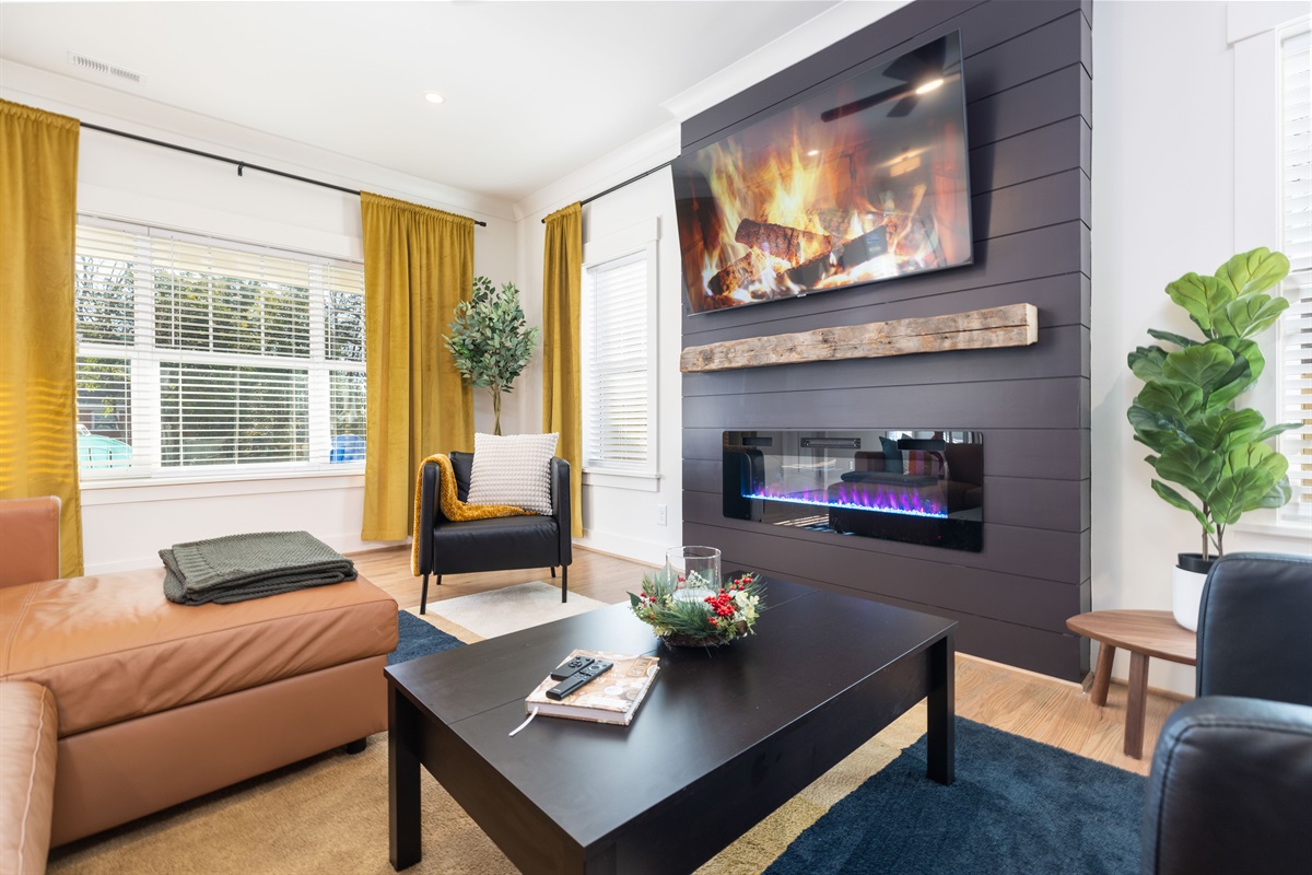 The spacious - and gorgeous - living room features a gas fireplace and large 65" smart TV loaded with all the apps. The main floor living room is the heart of the home. Close the blackout curtains for movie night! 