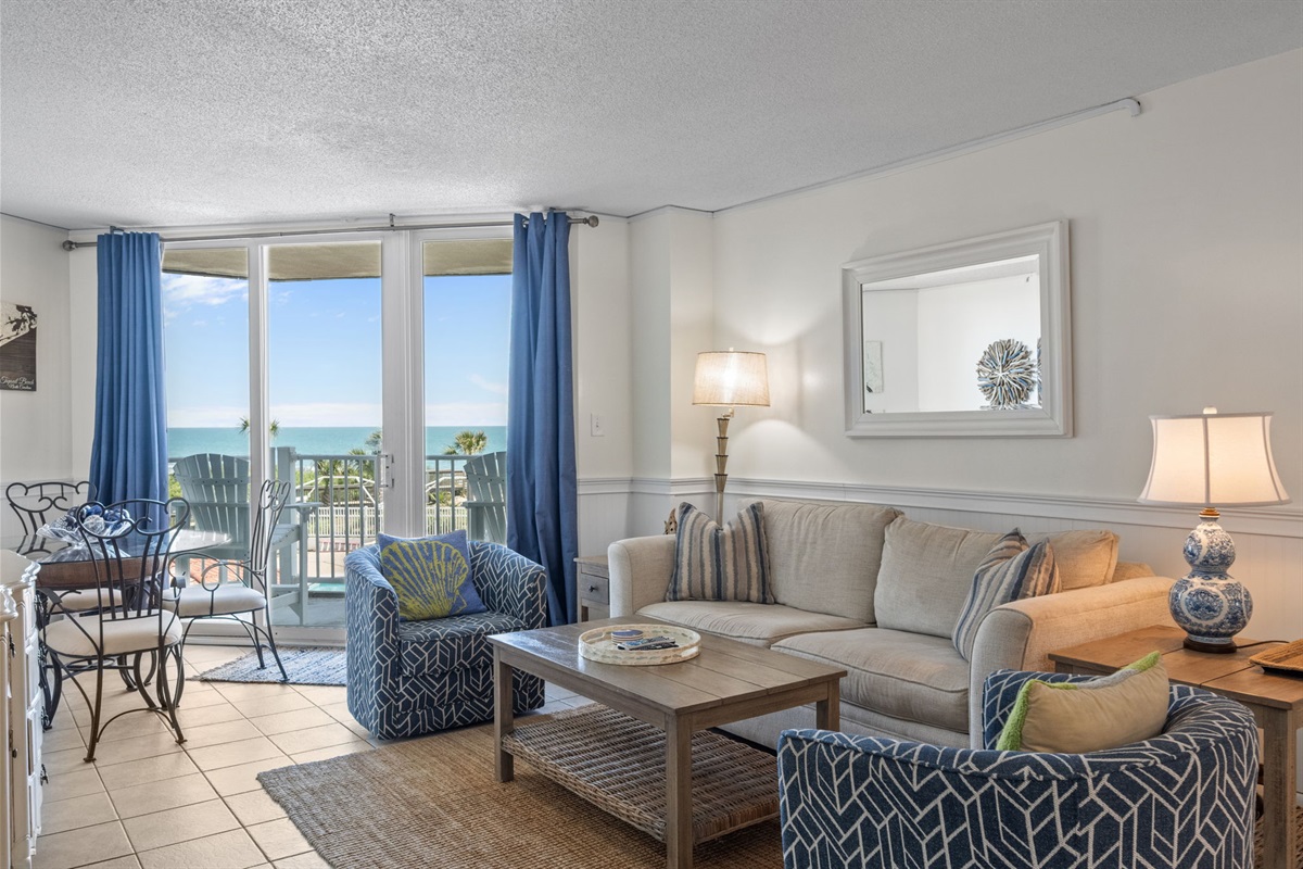 Open concept living space with ocean views that carry from the sofa straight to the balcony