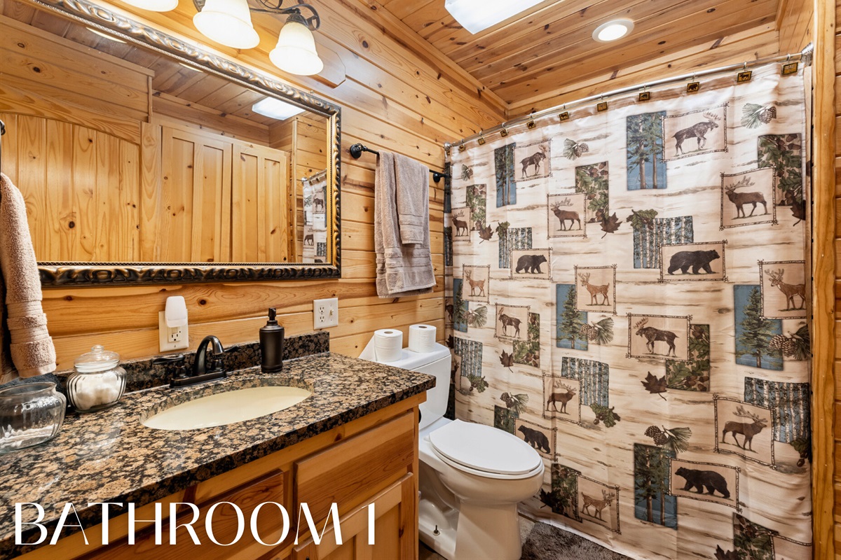 Bathroom 1 with rustic finishes and full shower/tub combo.