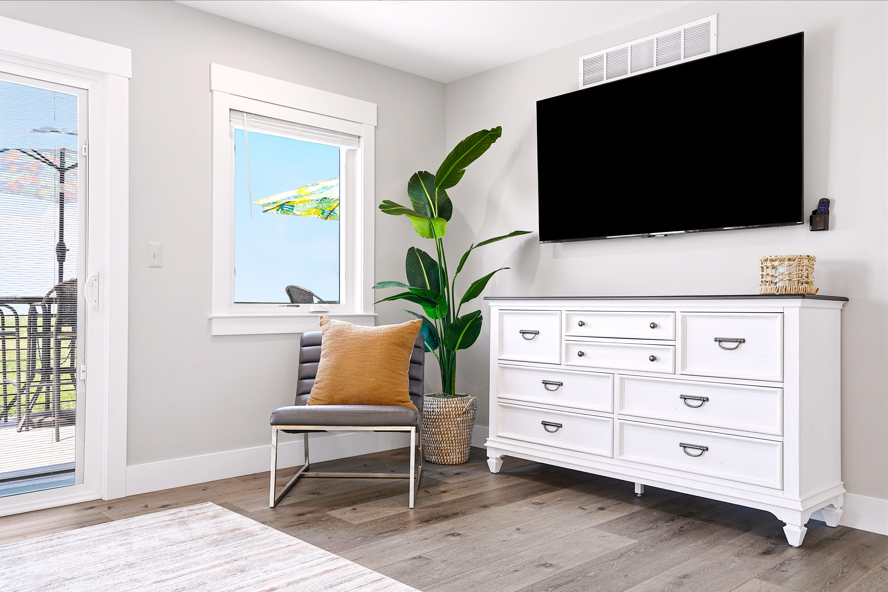 Thoughtfully designed for comfort, the suite features a 65" TCL Roku Smart TV, cozy accent chair, dresser, and plenty of natural light for relaxing any time of day.